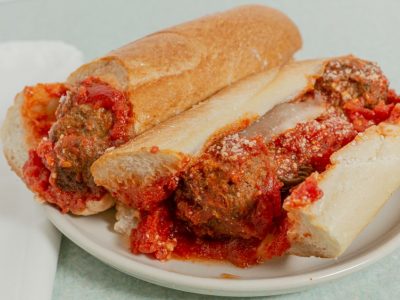 Meatball Parmigiana Meatballs, parmesan cheese, and marinara sauce in a hero roll.